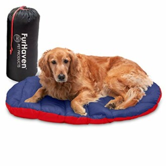 Golden retriever lying on a blue and red pet bed with a FurHaven storage bag.